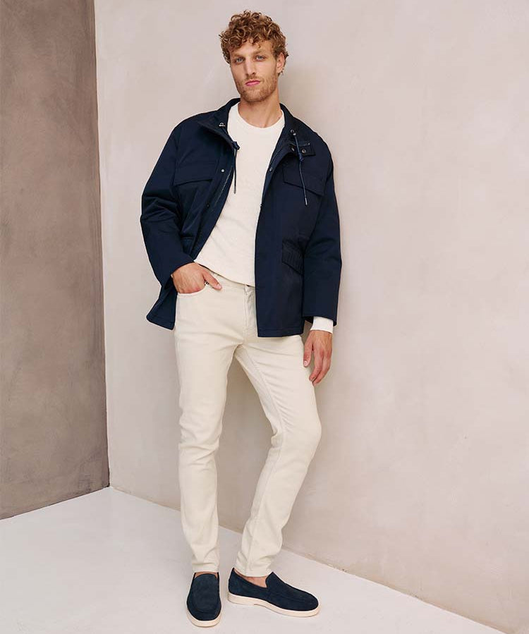 Man in beige Bukser jeans en blauwe jas